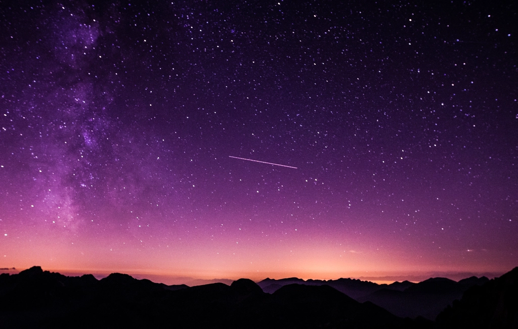 starry purple-hued night sky silhouettes